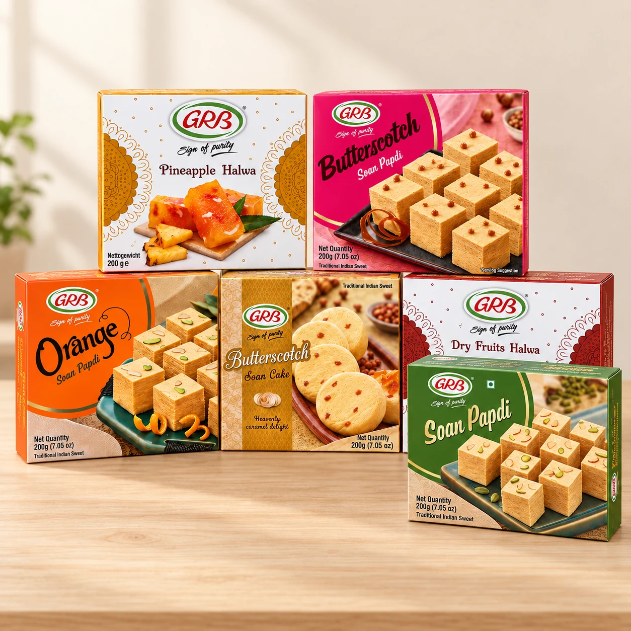 Six GRB Indian sweets arranged neatly on a light wooden table